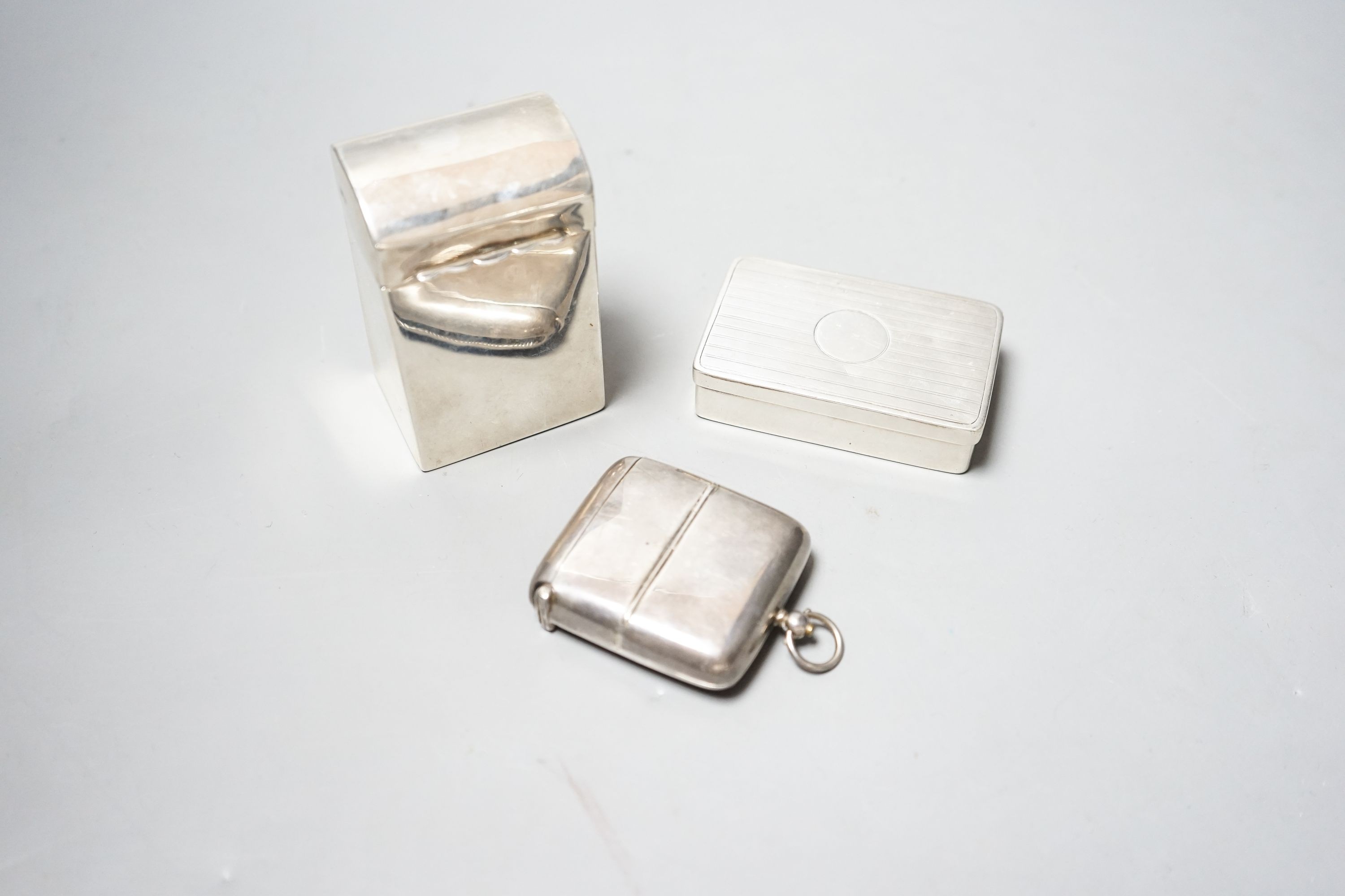 A late Victorian silver playing card box, Chester, 1900, 85mm, a similar snuff and a silver combination vesta case and sovereign/half sovereign case.